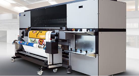 A large grey digital sign printer with a road sign being printed.